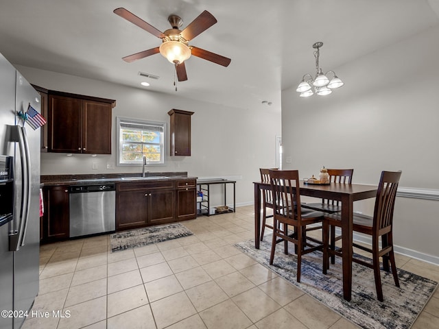 kitchen featuring dark brown cabinets, ceiling fan with notable chandelier, stainless steel appliances, sink, and light tile patterned floors