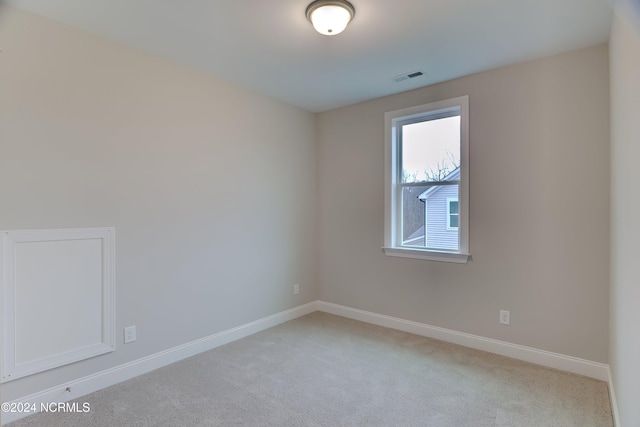 empty room featuring light carpet