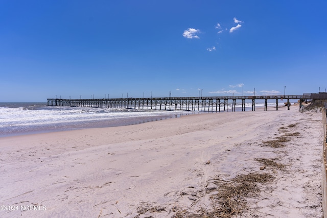 view of home's community with a water view and a view of the beach