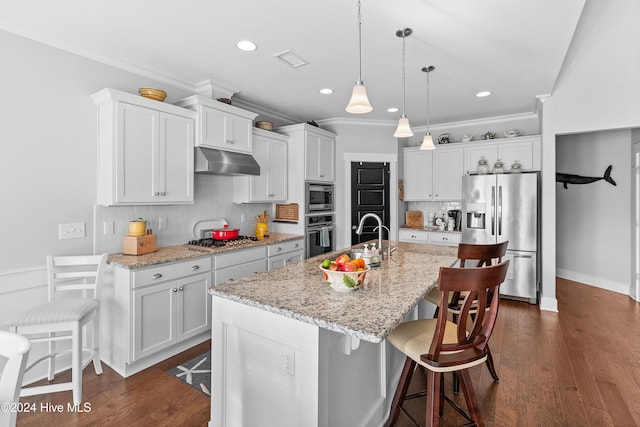 kitchen with white cabinetry, stainless steel appliances, and a center island with sink