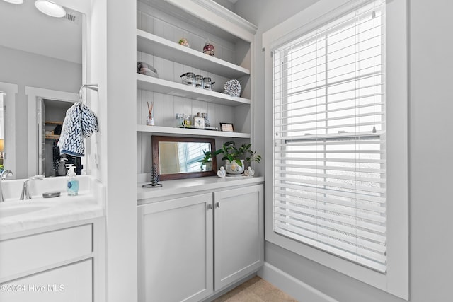 bar with sink and white cabinets