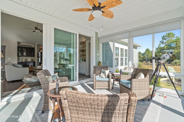 sunroom / solarium with wood ceiling and ceiling fan