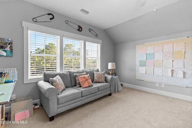 carpeted living room featuring vaulted ceiling and ceiling fan