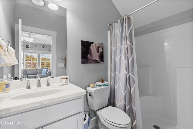 bathroom with vanity, toilet, a shower with curtain, and ceiling fan