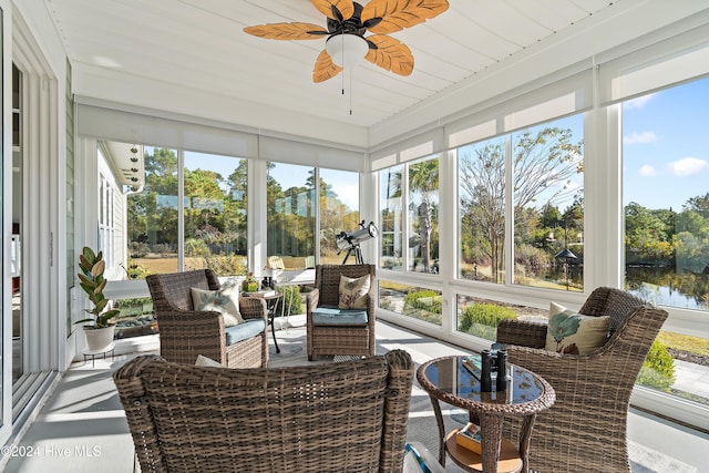 sunroom / solarium with a water view, wood ceiling, and ceiling fan