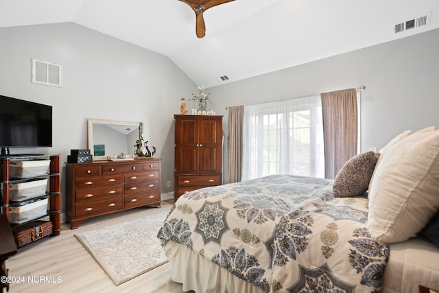 bedroom featuring lofted ceiling, light hardwood / wood-style flooring, and ceiling fan