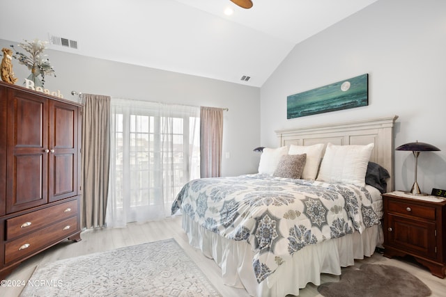 bedroom featuring lofted ceiling and light wood-type flooring