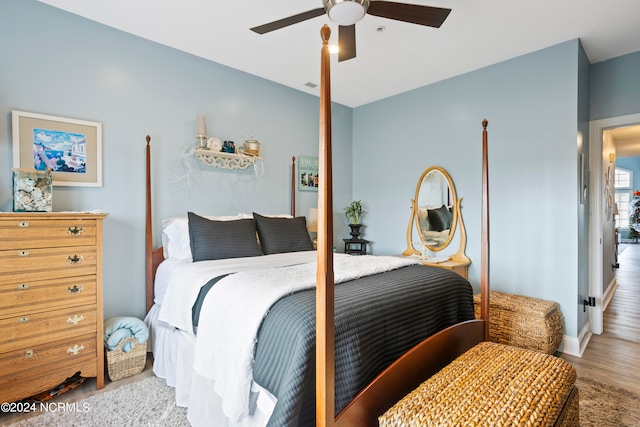 bedroom with light wood-type flooring and ceiling fan