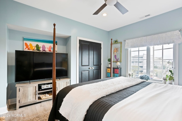 bedroom featuring a closet, ceiling fan, and light wood-type flooring