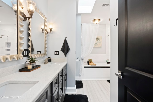 bathroom with vanity, hardwood / wood-style flooring, and independent shower and bath