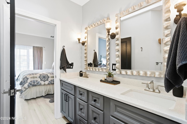 bathroom with vanity and hardwood / wood-style flooring