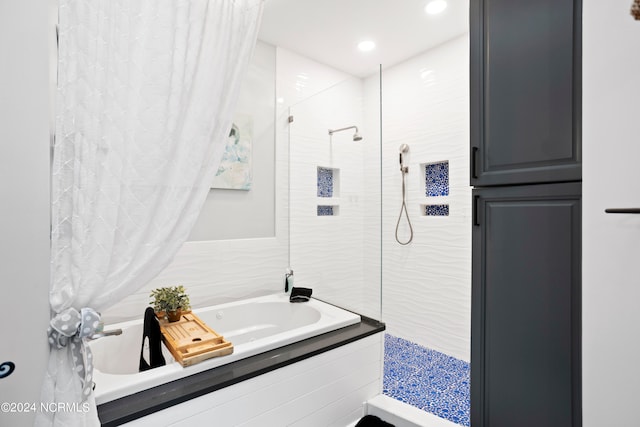 bathroom featuring shower with separate bathtub