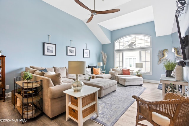 living room featuring lofted ceiling, hardwood / wood-style floors, and ceiling fan