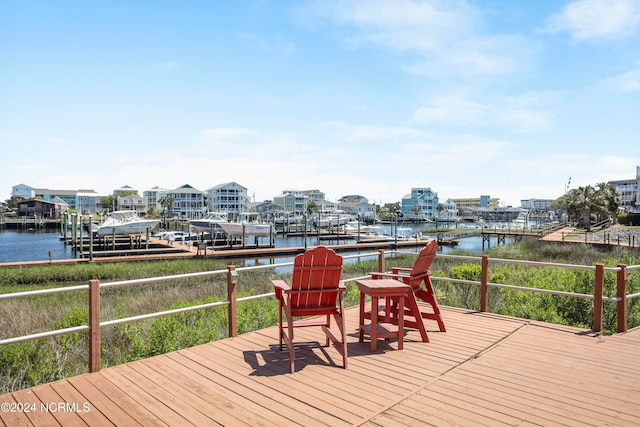 wooden deck with a water view and a boat dock