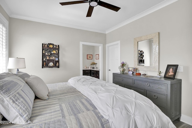 bedroom featuring ensuite bath, a ceiling fan, and crown molding