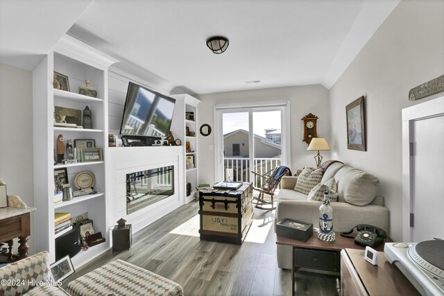 living room with light hardwood / wood-style floors and built in features