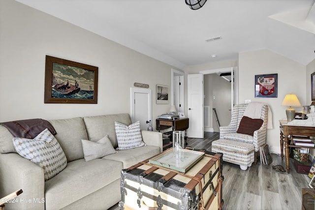 living area with visible vents and wood finished floors