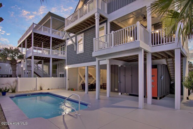 view of swimming pool with ceiling fan and a patio area