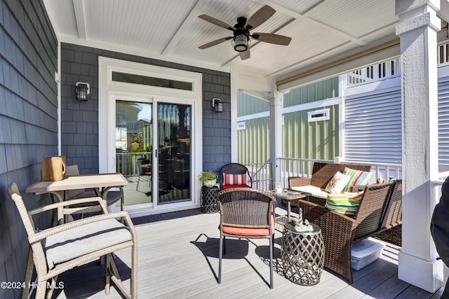 wooden terrace featuring ceiling fan and an outdoor hangout area