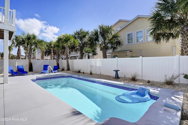 view of pool with a patio area, a fenced backyard, and a fenced in pool