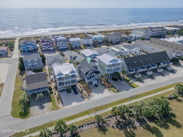 birds eye view of property featuring a water view and a view of the beach