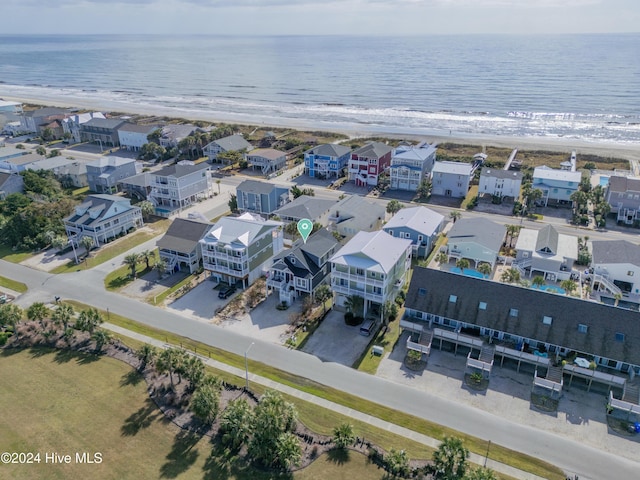 aerial view with a view of the beach, a water view, and a residential view