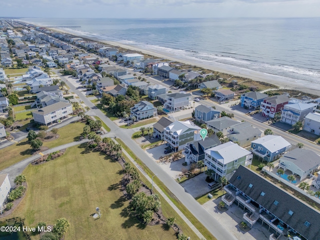 drone / aerial view featuring a beach view, a water view, and a residential view