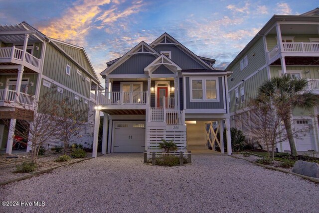 coastal inspired home with a porch and a garage