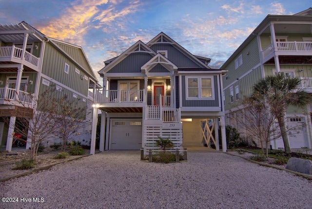 coastal inspired home with driveway, an attached garage, and board and batten siding