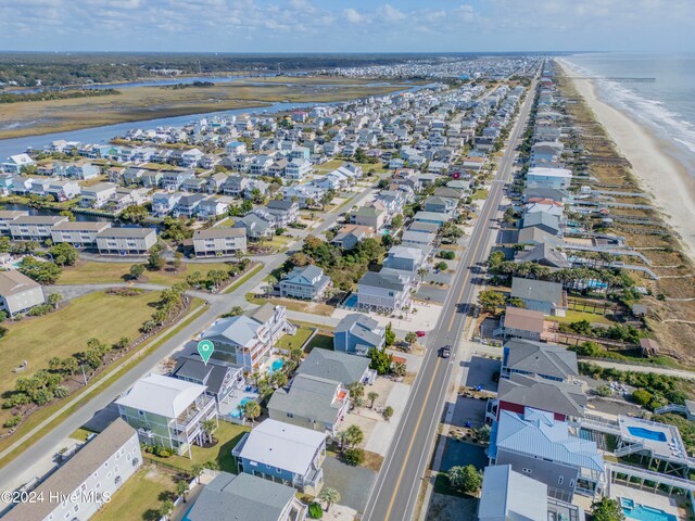 birds eye view of property featuring a water view and a view of the beach