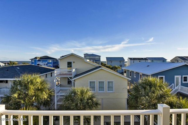 exterior space featuring a balcony and a residential view