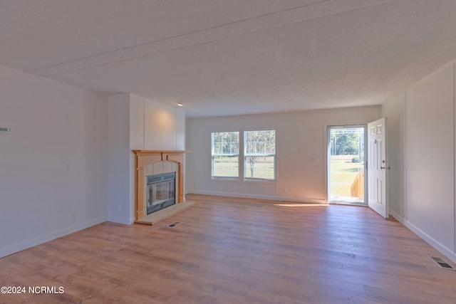 unfurnished living room featuring light hardwood / wood-style floors and a fireplace