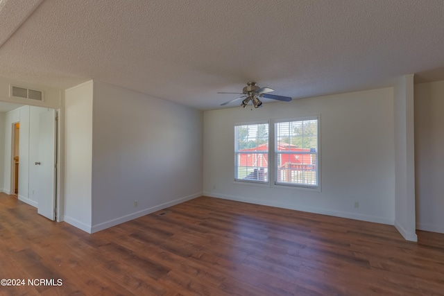 unfurnished room featuring a textured ceiling, dark hardwood / wood-style floors, and ceiling fan