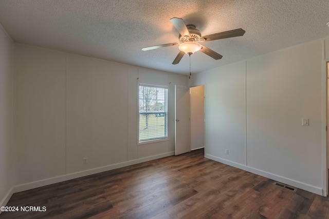 empty room featuring a textured ceiling, ceiling fan, and dark hardwood / wood-style flooring