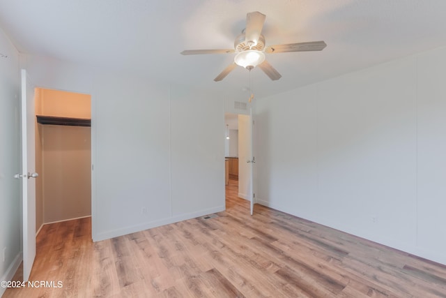 empty room featuring light wood-type flooring and ceiling fan