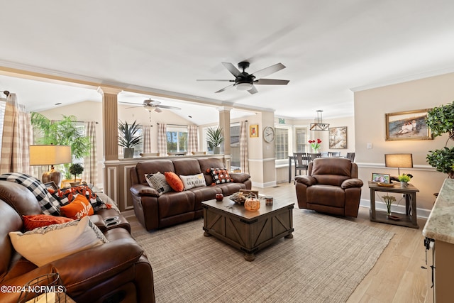 living room featuring vaulted ceiling, ornate columns, and light hardwood / wood-style flooring