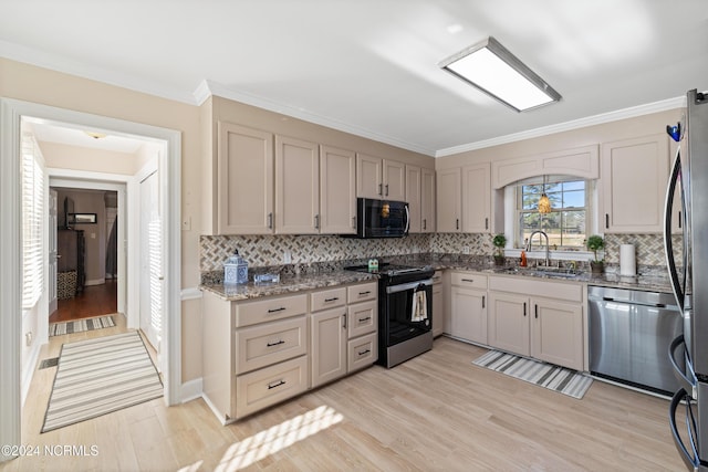 kitchen featuring backsplash, sink, ornamental molding, light hardwood / wood-style floors, and stainless steel appliances