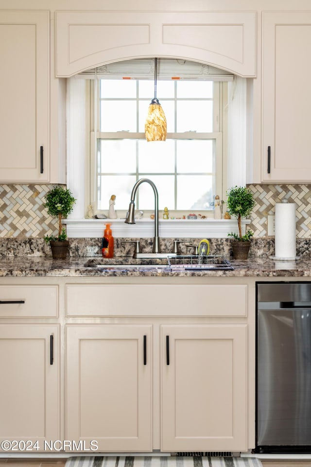 kitchen featuring stone counters, sink, dishwasher, white cabinetry, and tasteful backsplash