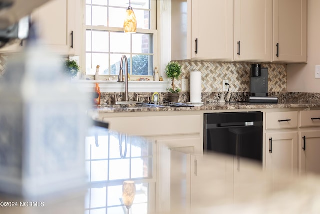 kitchen with white cabinets, stone countertops, backsplash, and sink