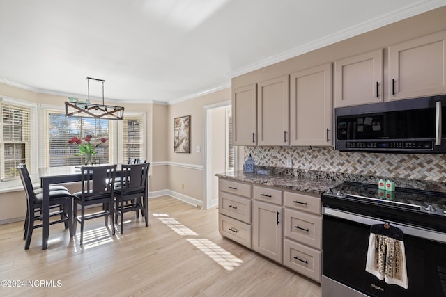 kitchen featuring dark stone counters, decorative backsplash, light wood-type flooring, and appliances with stainless steel finishes