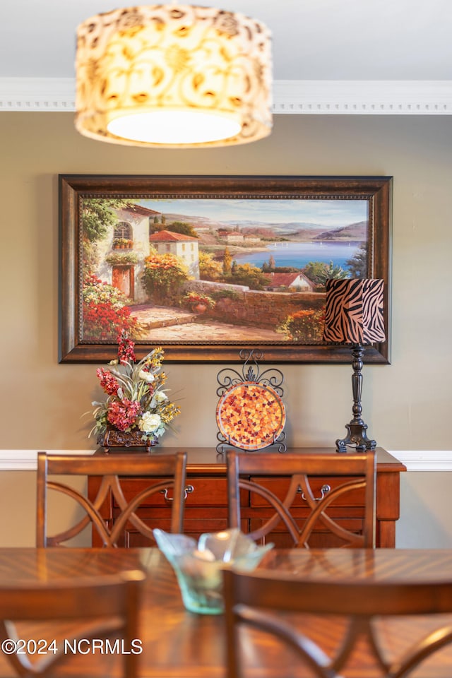 dining area featuring crown molding