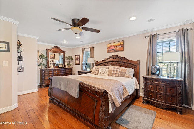 bedroom with ceiling fan, light hardwood / wood-style floors, and ornamental molding