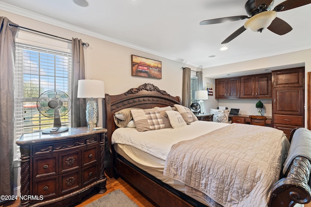 bedroom with ceiling fan, light hardwood / wood-style floors, and ornamental molding