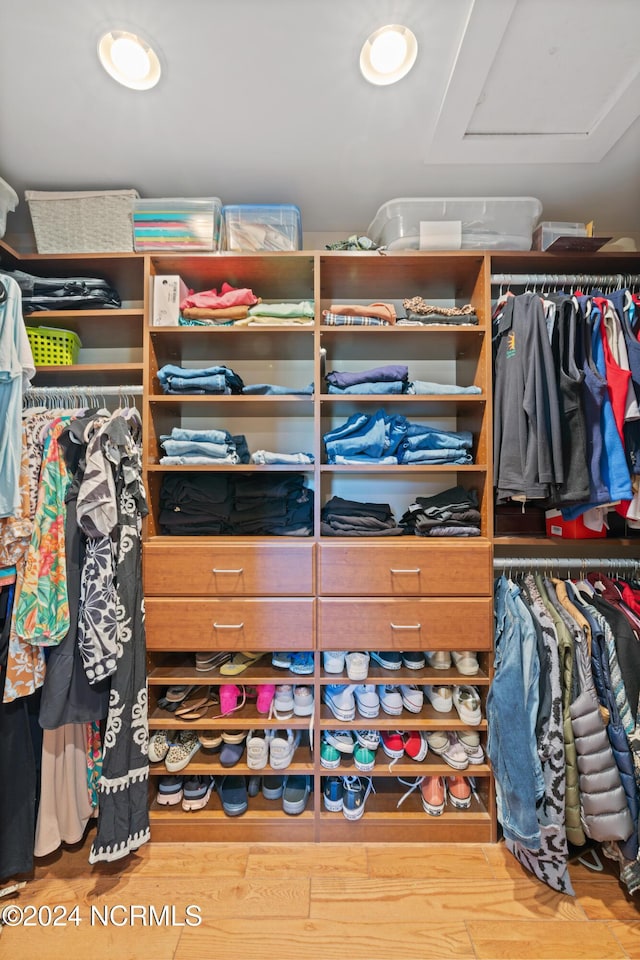 walk in closet with hardwood / wood-style flooring