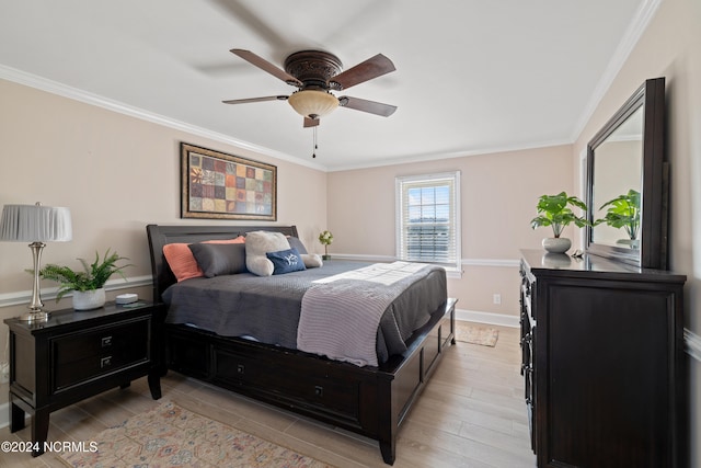 bedroom featuring ceiling fan, ornamental molding, and light hardwood / wood-style flooring