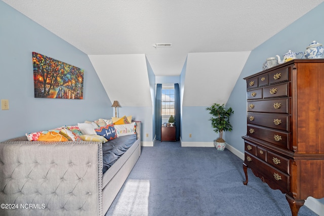 carpeted bedroom featuring a textured ceiling and lofted ceiling