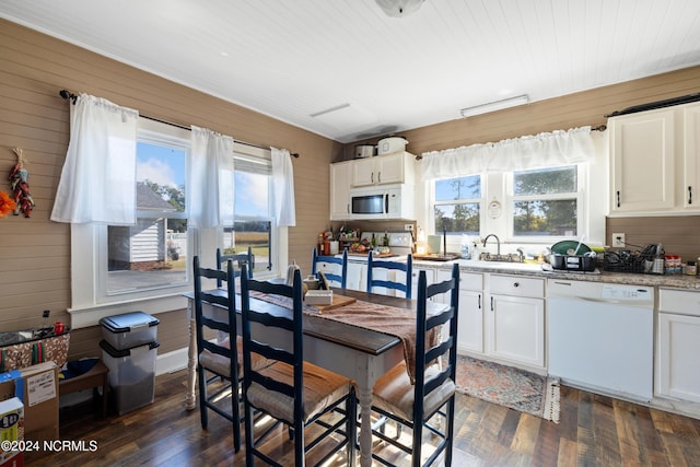 kitchen featuring white cabinetry, dark wood-type flooring, and white appliances