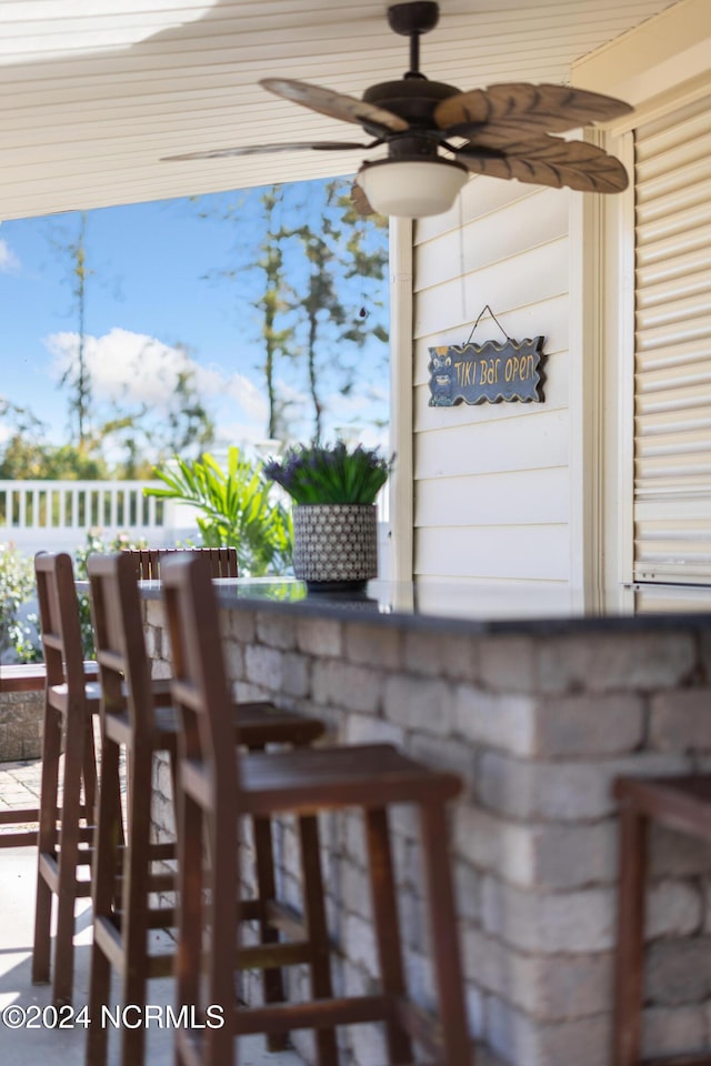 exterior space featuring ceiling fan and exterior bar