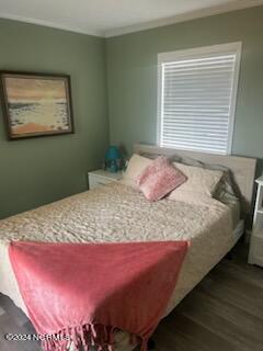 2196 New River Inlet Rd Unit 170, North Topsail Beach, NC 28460 - bedroom with wood finished floors and crown molding