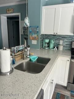 2196 New River Inlet Rd Unit 170, North Topsail Beach, NC 28460 - kitchen featuring white cabinets, a sink, light stone countertops, ornamental molding, and decorative backsplash